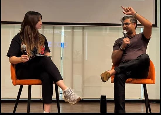 Ash Ali speaking on stage in Southeast Asia