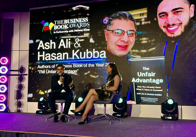 Ash Ali speaking on stage at The Business Book Awards with Hasan Kubba