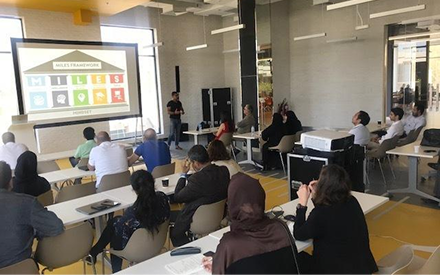 Ash Ali presenting the MILES framework to a seated audience at in5 Dubai